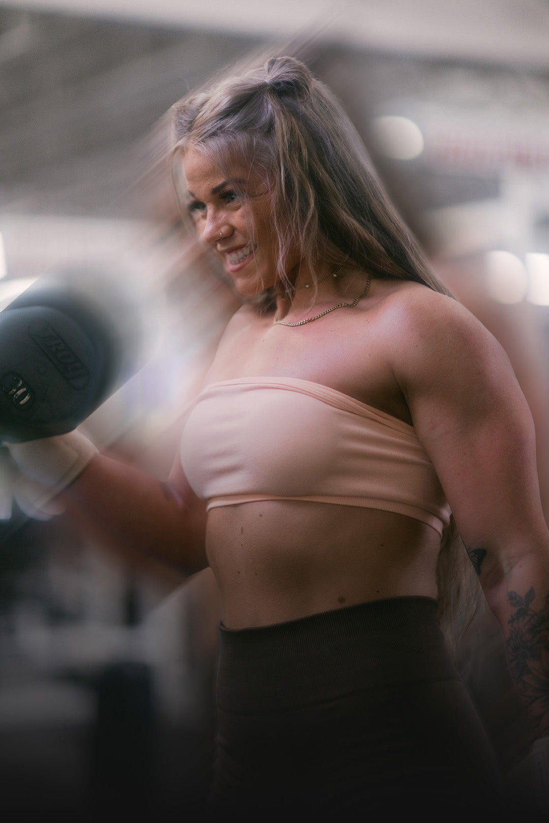 woman lifting with uppper wrist wraps