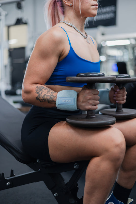 woman about to do upper chest exercise with uppper wrist wraps