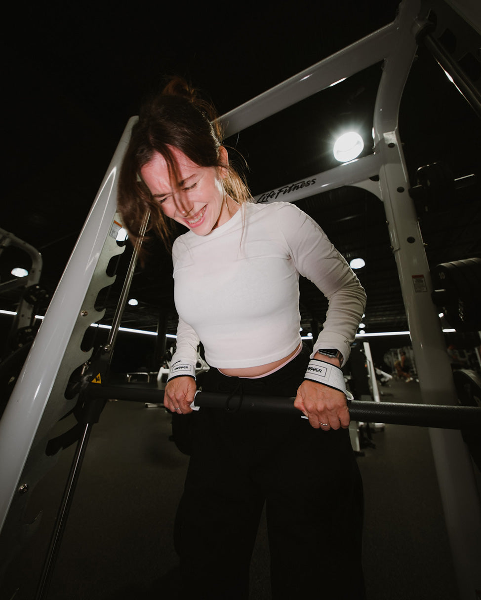 woman on pull day wearing uppper lifting straps